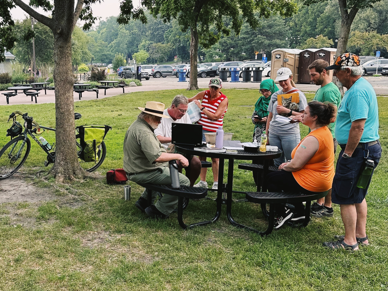 Camping and hiking equipment with a laptop on a stump in the woods